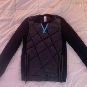 This is an Ivivva puffer crewneck in black size 12.